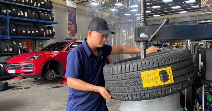 Kỹ thuật viên thay lốp ô tô cho khách hàng tại Thanh An Autocare quận 7