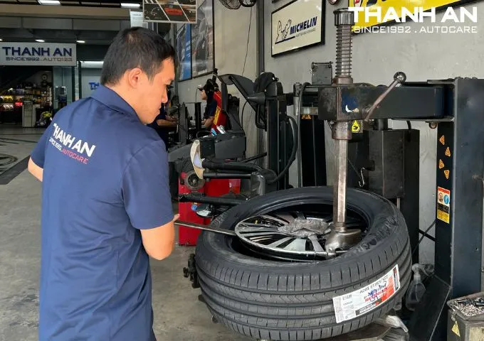 Kỹ thuật viên đang thay lốp xe Kia Sportage chính hãng tại gara