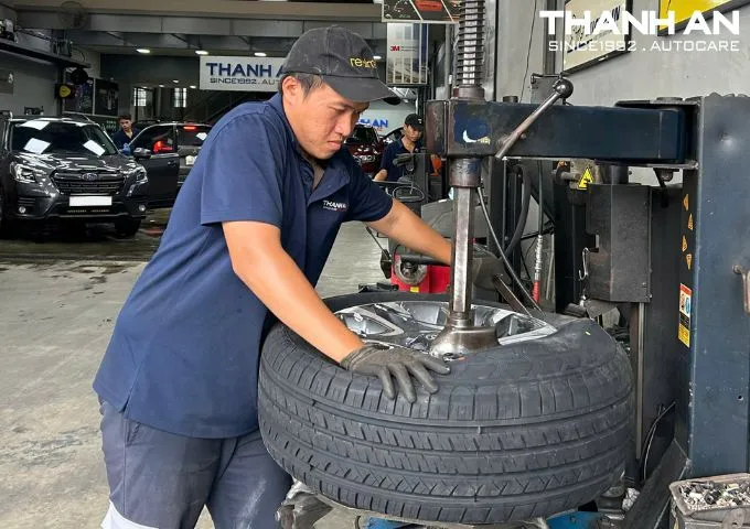 Kỹ thuật viên đang thay lốp xe Toyota Fortuner chính hãng tại gara